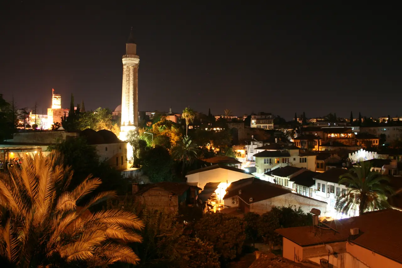 Kaleiçi rooftops and the Yivli Minaret lit up at night